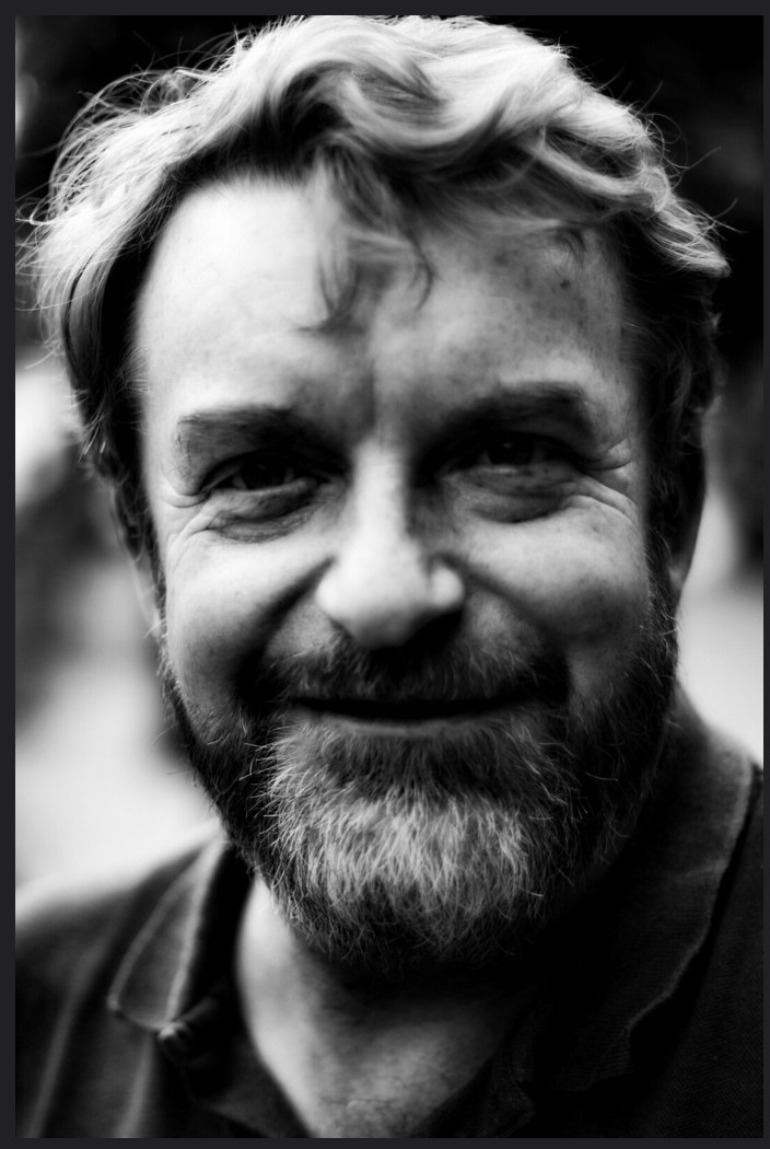 Danny O'Brien, smiling, in a black and white portrait